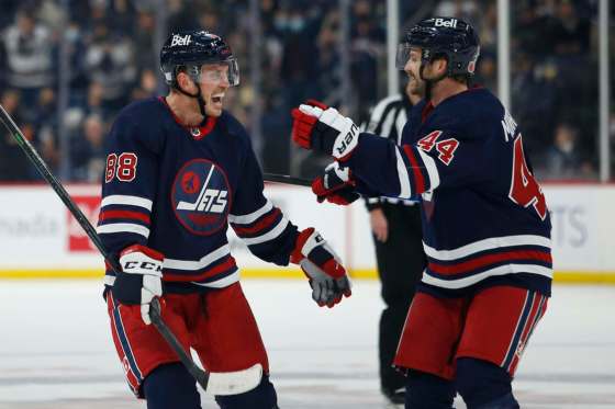 Winnipeg Jets' Nate Schmidt and Josh Morrissey celebrate Schmidt's goal against the San Jose Sharks during second period NHL action in Winnipeg on Thursday. THE CANADIAN PRESS/John Woods