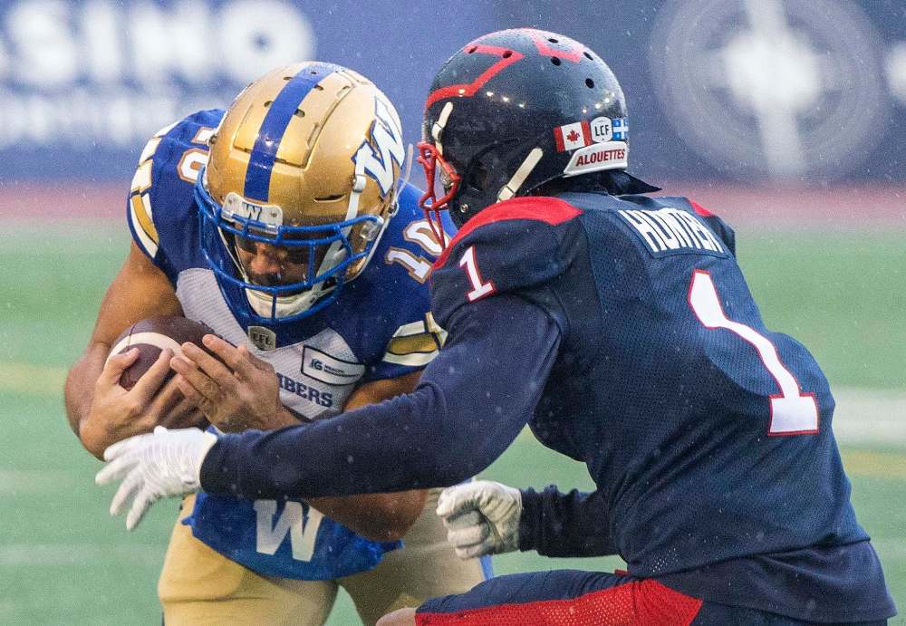 Winnipeg Blue Bombers' Nic Demski (10) is tackled by Montreal Alouettes' Monshadrik Hunter during the second half. (Graham Hughes / The Canadian Press)