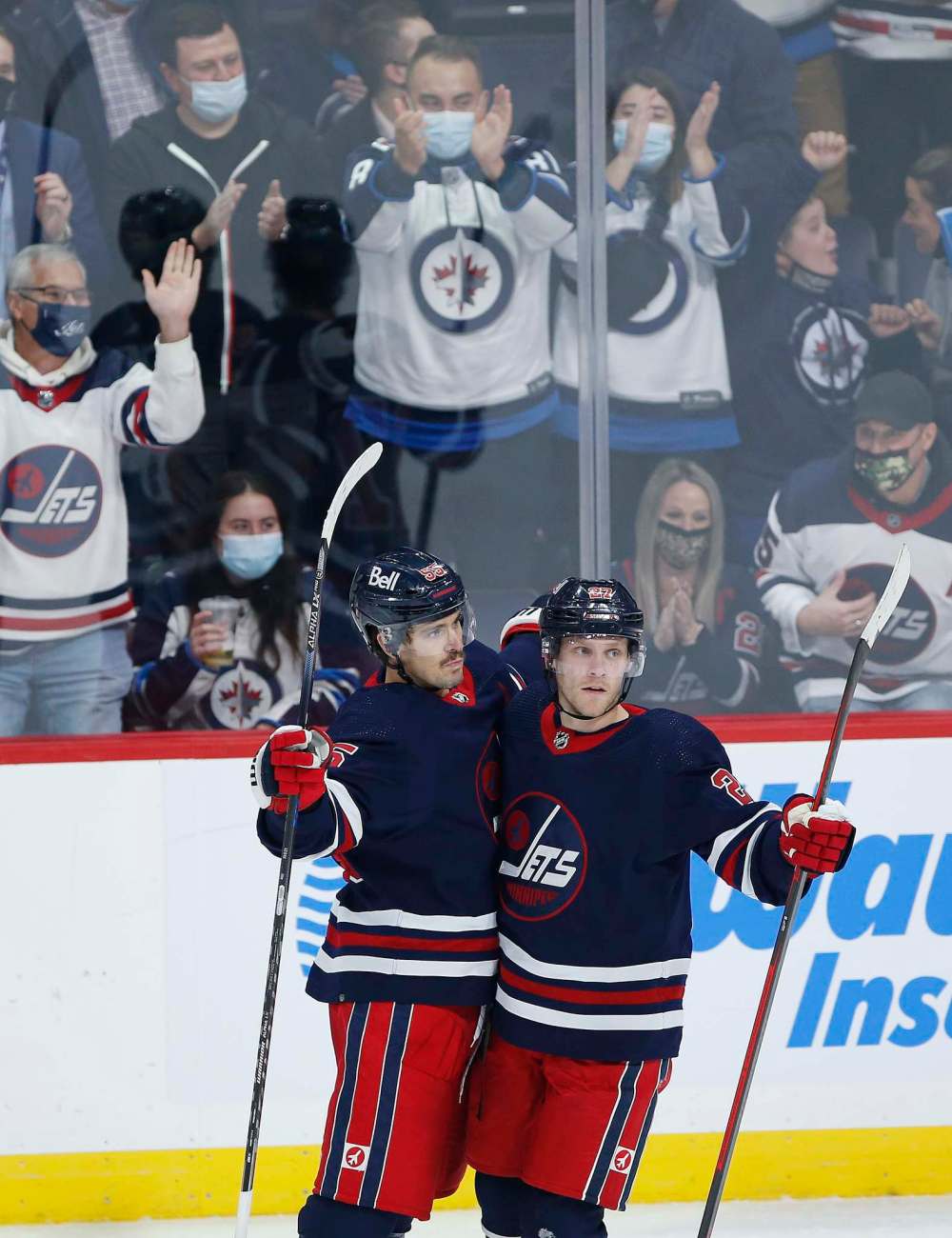 Winnipeg Jets' Mark Scheifele (55) and Nikolaj Ehlers (27) celebrate Scheifele’s game winning goal against the Los Angeles Kings during overtime. (John Woods / The Canadian Press)