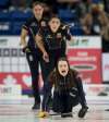 Skip Tracy Fleury shouts to her front end while team Einarson members Briane Meilleurm (back left) and Shannon Birchard look on. (Michael Burns / Curling Canada)