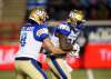 Bombers quarterback Zach Collaros handed off a few times, threw a few passes then hit the showers Saturday in Cowtown. When third-string running back Johnny Augustine (right) took a handoff, he made things happen. (Todd Korol / The Canadian Press files)