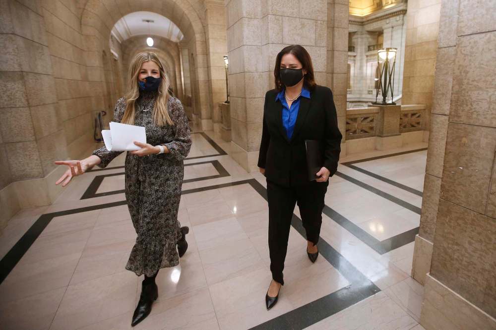 Manitoba Premier Heather Stefanson, right, walks to her office with her assistant Olivia Billson after speaking to media prior to the reading of the Speech from the Throne at the Manitoba Legislature Tuesday. THE CANADIAN PRESS/John Woods