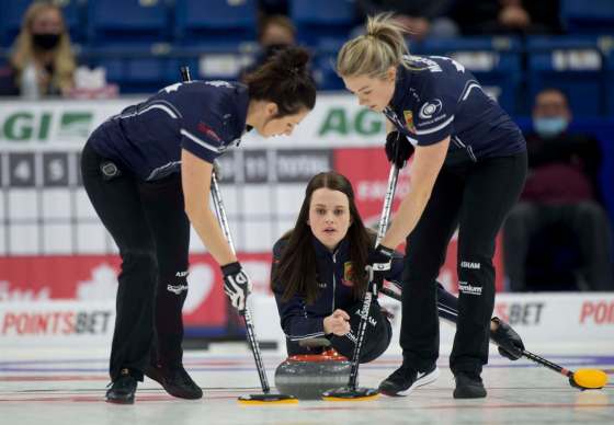 Michael Burns / Curling CanadaTracy Fleury (centre) watches as Liz Fyfe and Kristin MacCuish sweep her stone Thursday. The East St. Paul team has secured a spot in Sunday’s final of the Canadian Olympic Trials.