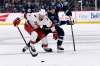 Winnipeg Jets' Mark Scheifele and Carolina Hurricanes’ Brendan Smith compete for a loose puck during the second period of the 4-2 Carolina win in Winnipeg on Tuesday. THE CANADIAN PRESS/Fred Greenslade