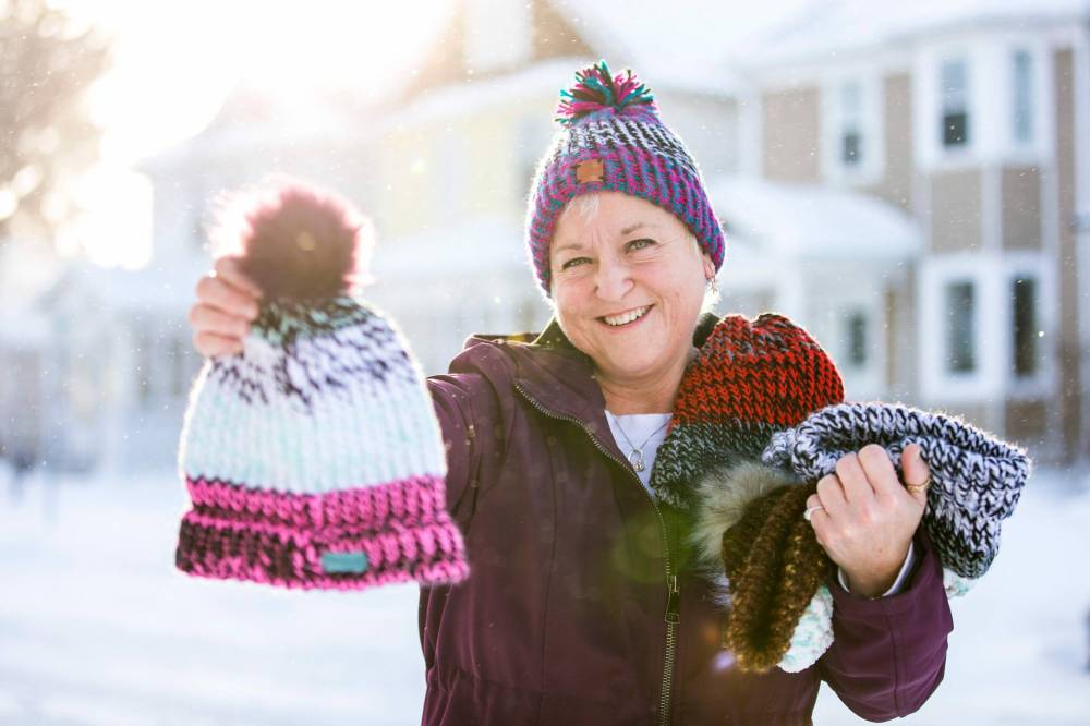 MIKAELA MACKENZIE / WINNIPEG FREE PRESS
Kyla Simms poses for a portrait with her toques in Winnipeg. She is an armed forces veteran who has made so many toques that she was able to give some to fellow patients and nurses at the health care facility in Ontario she was at and has recently donated 50 of them to Main Street Project.