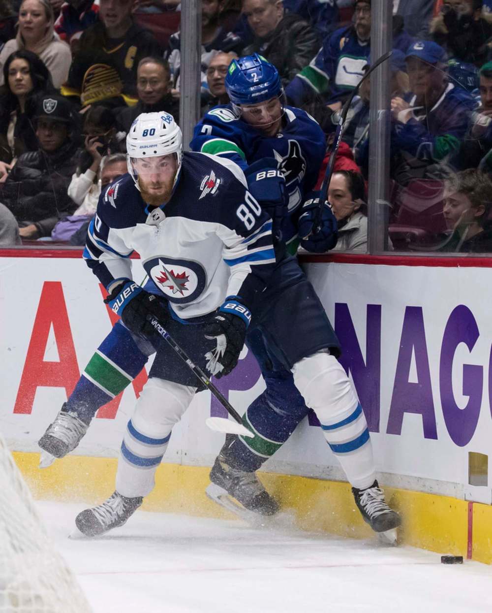 Winnipeg Jets' Pierre-Luc Dubois and Vancouver Canucks' Luke Schenn collide during the first period. THE CANADIAN PRESS/Darryl Dyck