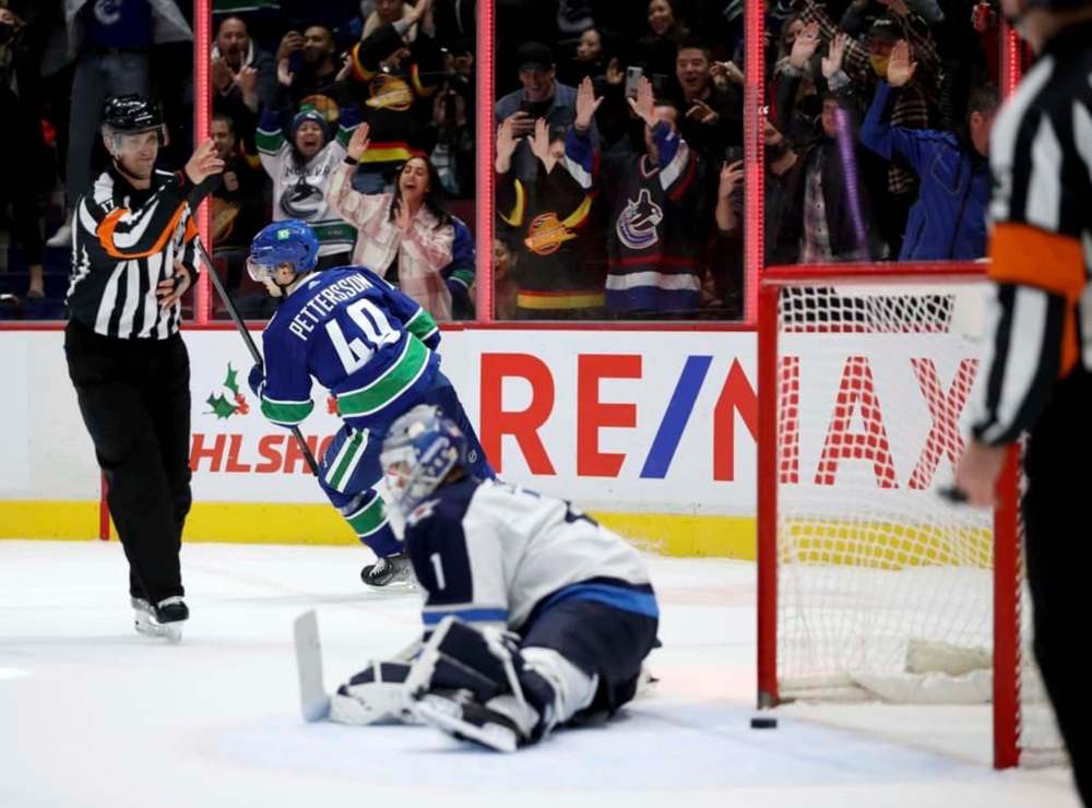 Vancouver Canucks' Elias Pettersson scores the game-winning goal on Winnipeg Jets' goaltender Eric Comrie during the shootout, Friday. (TREVOR HAGAN / WINNIPEG FREE PRESS)
