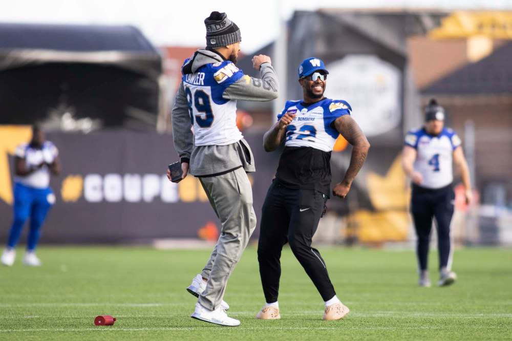 Bombers players such as Kenny Lawler (left) and Alden Darby were loose and relaxed Saturday during practice, but they'll be all business when game time comes around. (Nick Iwanyshyn / The Canadian Press)