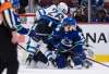 Winnipeg Jets' Blake Wheeler's leg bends sideways at the knee as he battles for the puck against Vancouver Canucks' Vasily Podkolzin, front right, of Russia, during the third period of an NHL hockey game in Vancouver, on Friday. Wheeler left the game due to the injury and did not return to the ice. THE CANADIAN PRESS/Darryl Dyck