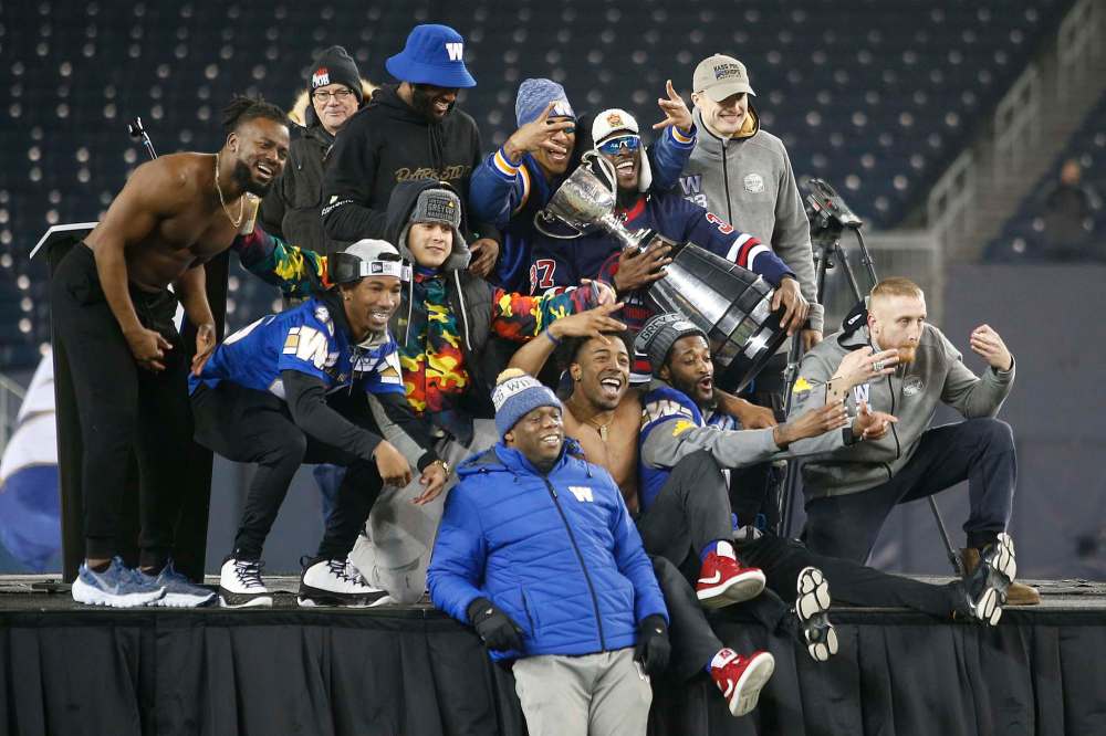 Winnipeg Blue Bombers celebrate after their Grey Cup win In Winnipeg on Wednesday. THE CANADIAN PRESS/John Woods