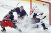 Winnipeg Jets goaltender Connor Hellebuyck saves the shot from Washington Capitals' Beck Malenstyn as Kristian Vesalainen defends during the first period. THE CANADIAN PRESS/John Woods