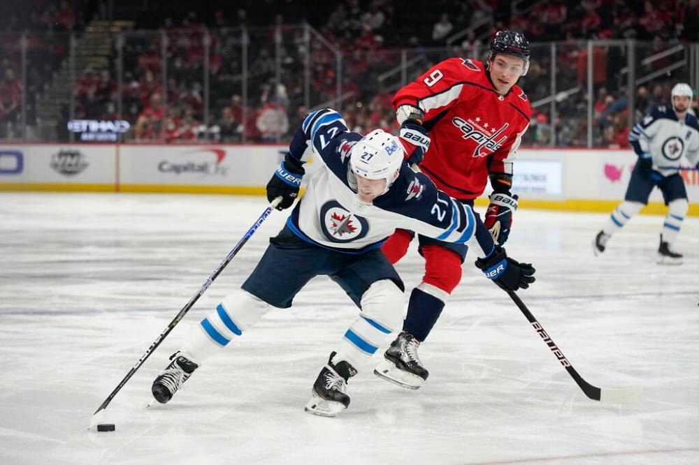Winnipeg Jets left wing Nikolaj Ehlers (27) tries to maintain possession as he is pressured by Washington Capitals defenceman Dmitry Orlov in the first period Tuesday. (AP Photo/Patrick Semansky)