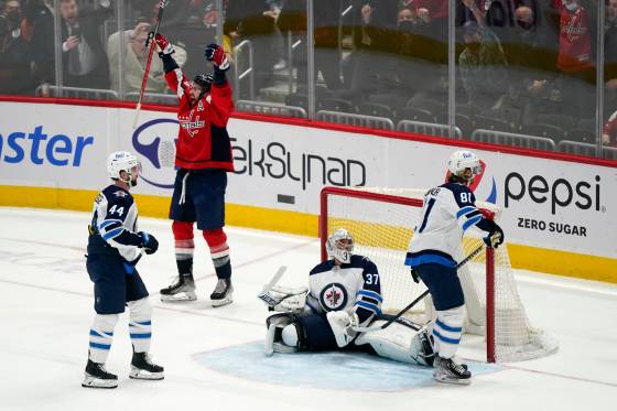 Washington Capitals right wing Tom Wilson celebrates after scoring the game-winning goal in front of Winnipeg Jets defenceman Josh Morrissey (44), goaltender Connor Hellebuyck (37) and left wing Kyle Connor (81) in overtime. (AP Photo/Patrick Semansky)