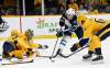 Winnipeg Jets center Paul Stastny (25) attempts to get a shot off between Nashville Predators goaltender Juuse Saros (74) and center Mikael Granlund (64) during the first period Thursday in Nashville, Tenn. (AP Photo/Mark Zaleski)