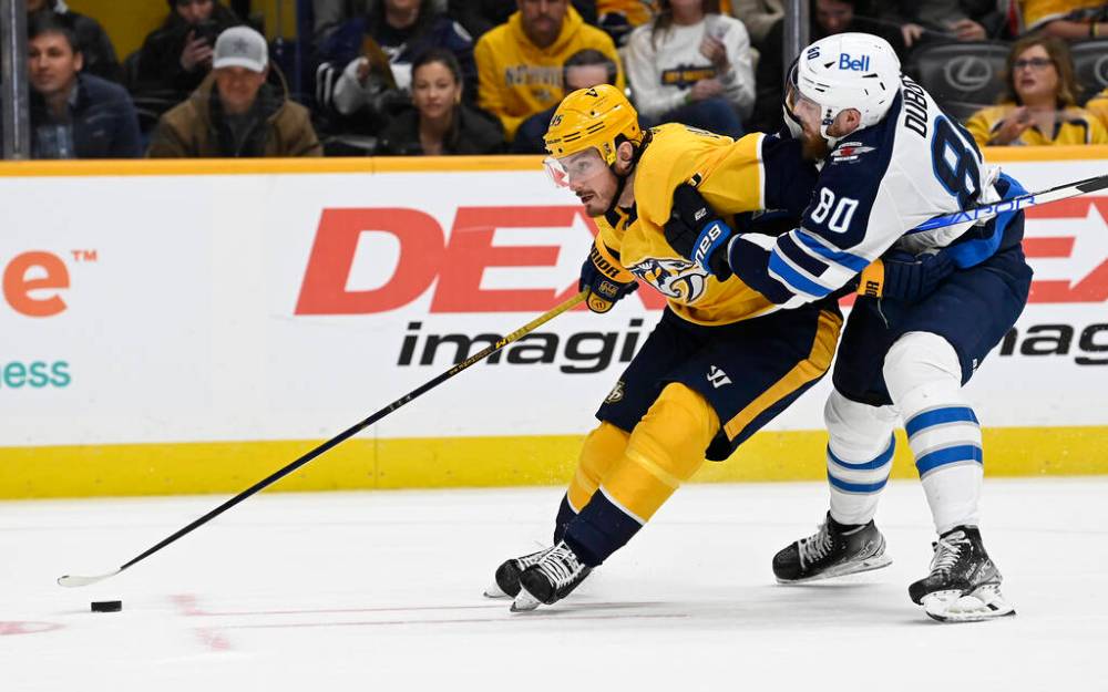 Nashville Predators centre Matt Duchene, left, moves the puck in front of Winnipeg Jets left wing Pierre-Luc Dubois during the second period. (AP Photo/Mark Zaleski)