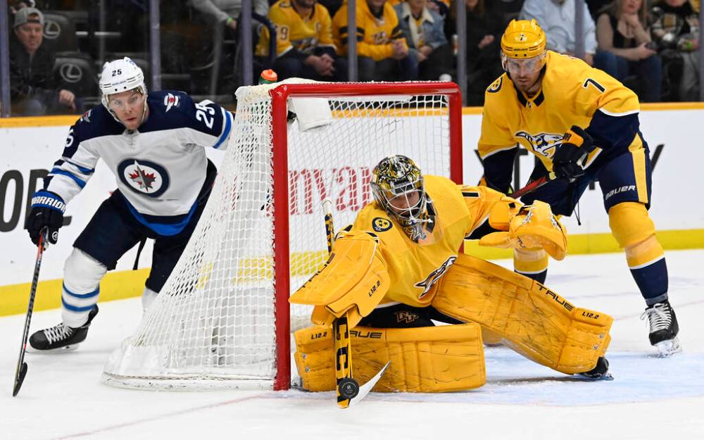 Nashville Predators goaltender Juuse Saros clears the puck away from Winnipeg Jets centre Paul Stastny during the first period Thursday, in Nashville, Tenn. (AP Photo/Mark Zaleski)