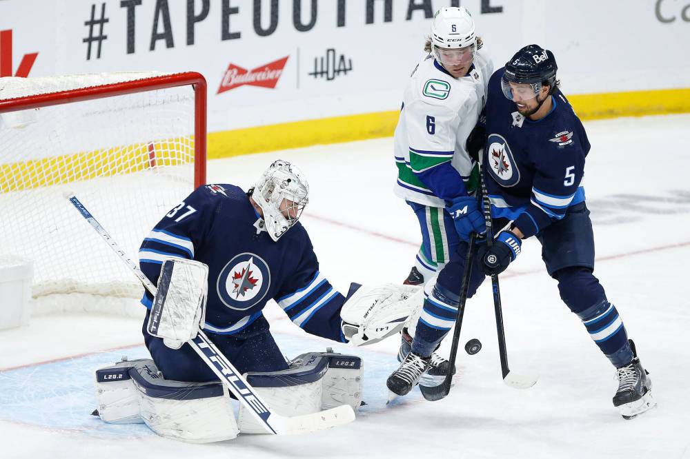 Jets netminder Hellebuyck shares details of brush with COVID as Winnipeg  players now 100% vaccinated