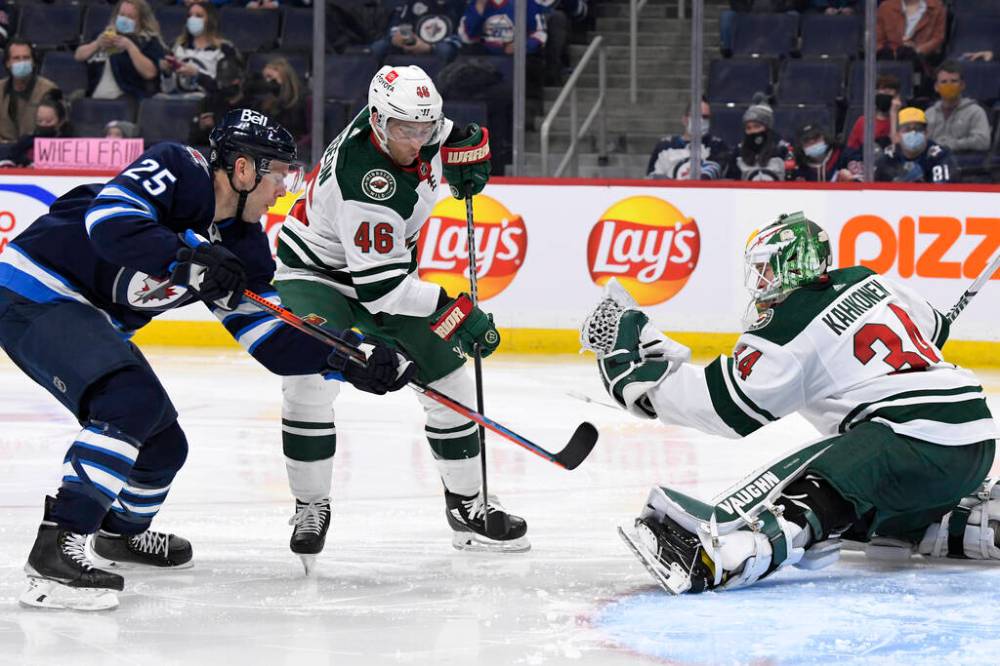 Minnesota Wild goaltender Kaapo Kahkonen makes a save as Winnipeg Jets’ Paul Stastny and Wild’s Jared Spurgeon watch for any rebound during the second period. THE CANADIAN PRESS/Fred Greenslade