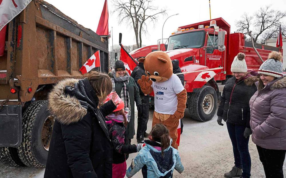 A mascot waves to children at the protest. (David Lipnowski / Winnipeg Free Press)