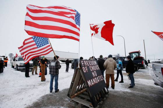 John Woods / The Canadian PressPeople block highway 75 with heavy trucks and farm equipment and access to the Canada/US border crossing at Emerson, Man., Thursday, Feb. 10, 2022. The blockade was set up to rally against provincial and federal COVID-19 vaccine mandates and in support of Ottawa protestors. THE CANADIAN PRESS/John Woods