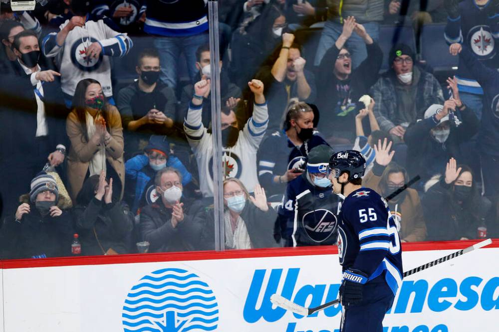 Winnipeg Jets' Mark Scheifele and fans celebrate his second goal of the game against the Minnesota Wild during the second period in Winnipeg on Wednesday. THE CANADIAN PRESS/John Woods
