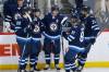 Winnipeg Jets' Pierre-Luc Dubois (80), Josh Morrissey (44), Mark Scheifele (55), Kyle Connor (81) and Blake Wheeler (26) celebrate Scheifele’s second goal of the game against the Minnesota Wild during the second period. THE CANADIAN PRESS/John Woods