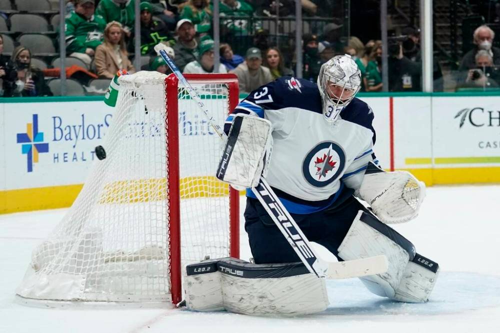 Winnipeg Jets goaltender Connor Hellebuyck deflects a shot from the Dallas Stars in the first period. (AP Photo/Tony Gutierrez)