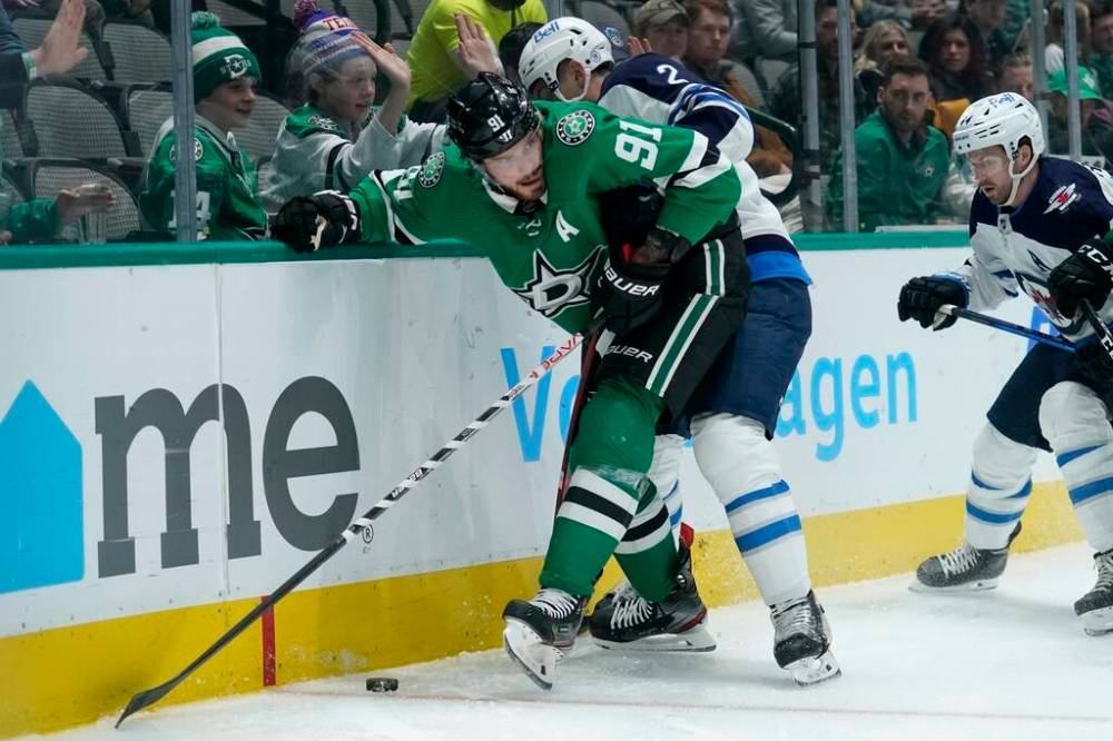 Dallas Stars centre Tyler Seguin works against Winnipeg Jets defenceman Dylan DeMelo for control of the puck in the first period. (AP Photo/Tony Gutierrez)