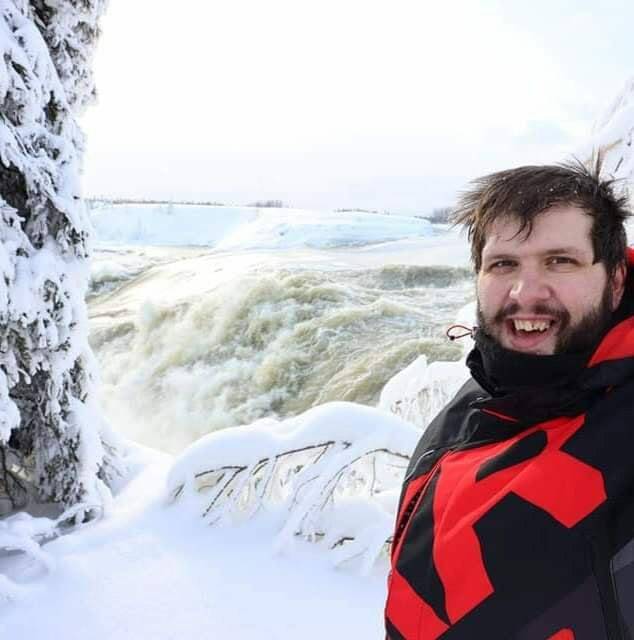 Thompson Trail Breakers snowmobiling club president Dennis Foley stands at the top of Managan Falls after a short trip via snowmobile. (Supplied)