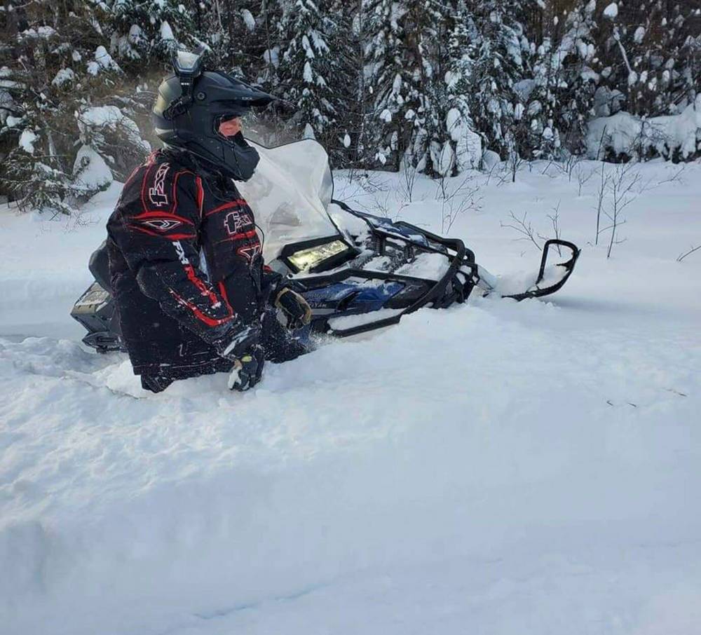 Denis Foley wades through waist-deep snow as he checks out a trail. (Supplied)