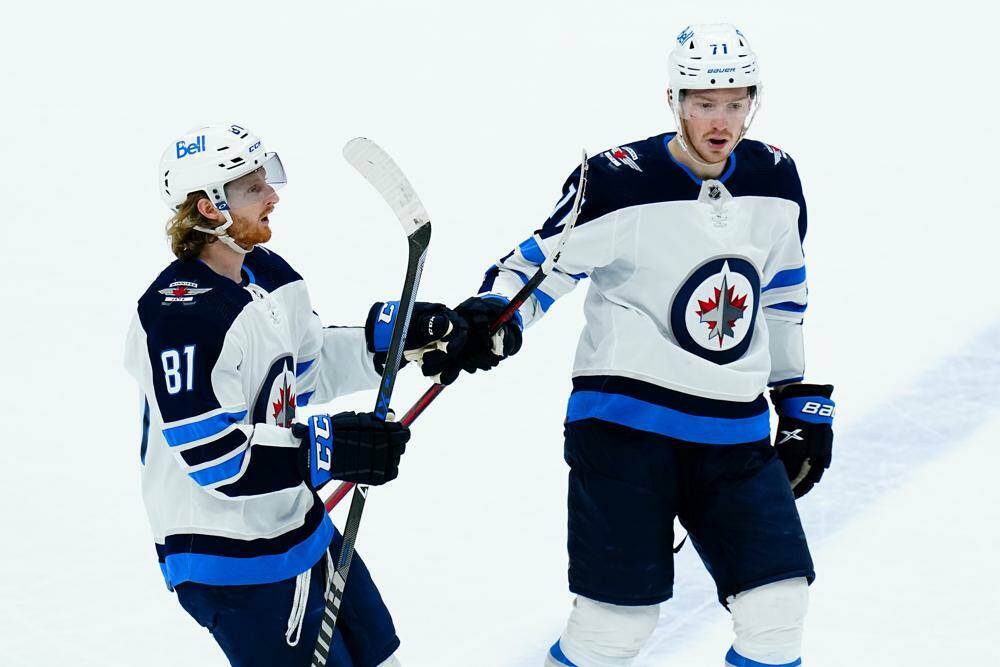 Kyle Connor (left) and Evgeny Svechnikov celebrate one of Connor's goals. He notched a pair Sunday afternoon in Phoenix to give him 32 on the season, while Svehcnikov added his fifth. (Ross D. Franklin / The Associated Press)