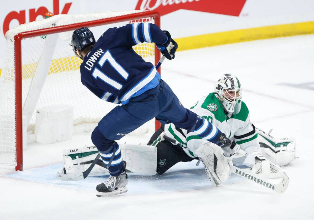 Dallas Stars goaltender Braden Holtby saves a breakaway shot from Winnipeg Jets’ Adam Lowry during the first period. THE CANADIAN PRESS/John Woods