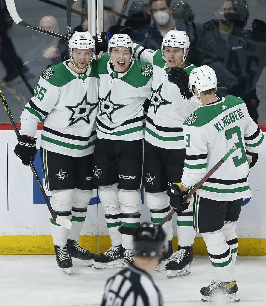 Dallas Stars players celebrate Jason Robertson’s goal against the Winnipeg Jets during the second period. THE CANADIAN PRESS/John Woods