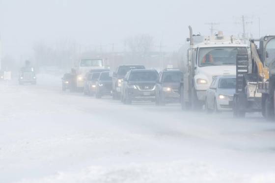 Tow trucks and other vehicles on McGillivray Boulevard. (Mike Deal / Winnipeg Free Press)