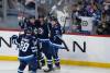 Winnipeg Jets’ Nate Schmidt (88), Neal Pionk (4), Kyle Connor (81) and Dominic Toninato (21) celebrate Connor’s game winning goal against the Tampa Bay Lightning during the third period in Winnipeg on Tuesday. THE CANADIAN PRESS/Fred Greenslade