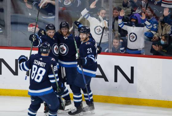 Winnipeg Jets’ Nate Schmidt (88), Neal Pionk (4), Kyle Connor (81) and Dominic Toninato (21) celebrate Connor’s game winning goal against the Tampa Bay Lightning during the third period in Winnipeg on Tuesday. THE CANADIAN PRESS/Fred Greenslade