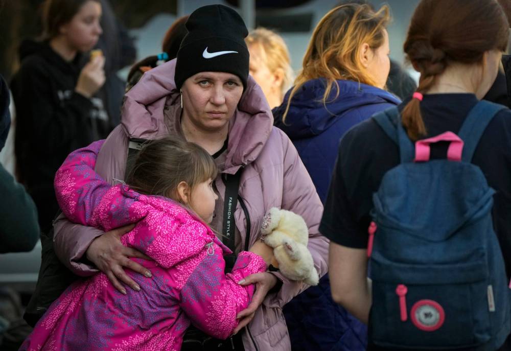 Sergei Grits / The Associated Press
A Ukrainian family waits for a transport at a railway station in Przemysl, Poland, Tuesday after fleeing the war in neighbouring Ukraine.
Sergei Grits / The Associated Press
A Ukrainian family waits at a railway station in Przemysl, Poland, on Tuesday after fleeing the war in neighbouring Ukraine.