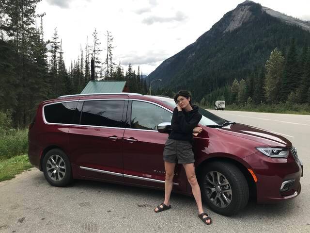 Supplied / Steven Bochenek Justine Bochenek poses with the minivan her dad Steven drove across country in to help her move to Ontario from British Columbia.