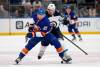 New York Islanders’ Brock Nelson tries to keep the puck from Winnipeg Jets defenceman Nate Schmidt during the first period. (AP Photo/Jim McIsaac)