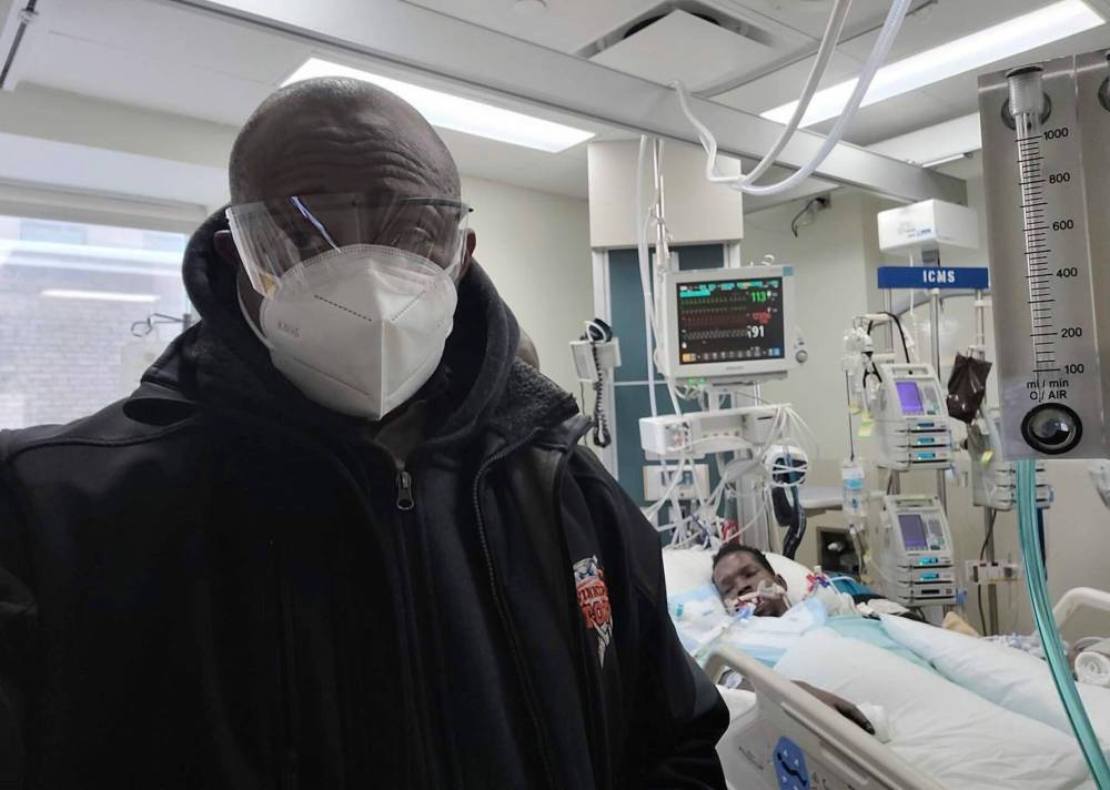 SUPPLIED
Uche Nwanko in St. Boniface Hospital ICU with Tevin Obiga, who left behind a $550,000 medical bill. His single mom can’t afford the $20K to repatriate his remains to Kenya.