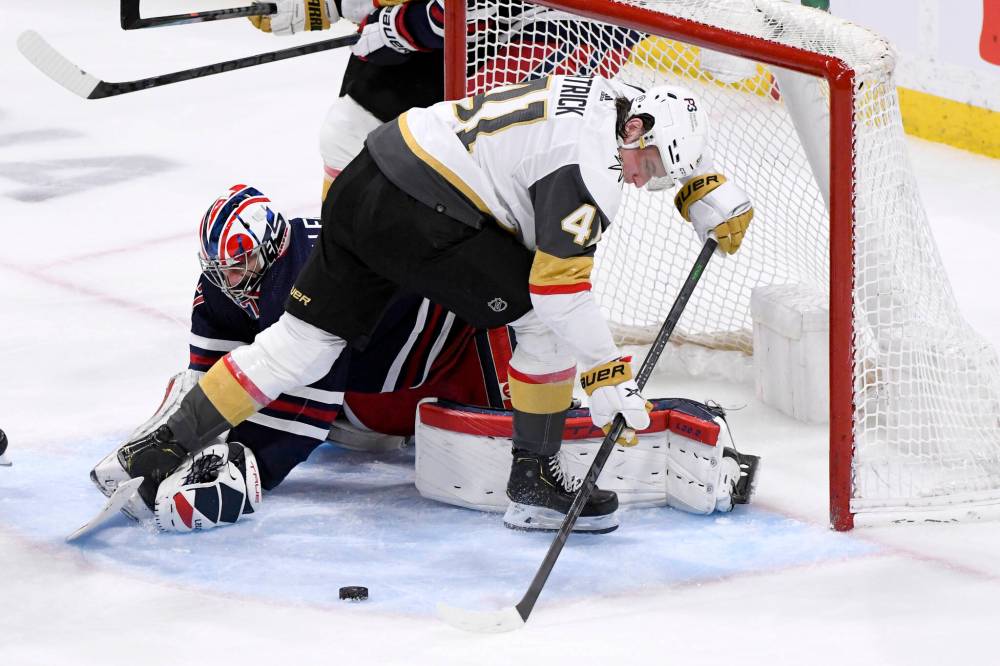 Winnipeg Jets goaltender Connor Hellebuyck makes a save on Vegas Golden Knights’ Nolan Patrick during the third period. THE CANADIAN PRESS/Fred Greenslade