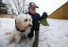 JOHN WOODS / WINNIPEG FREE PRESS Jake Hultin carries a bag of his puppy Maui’s poop as they go for a walk Tuesday, March 22, 2022. Nine year old Hutlin wrote a letter to the city after he noticed that Charleswood is lacking garbage cans for him to drop his doggie bags and litter while out for a walk. Hutlin is asking the city to put out more garbage cans. Re: Joyanne