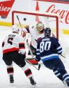 Winnipeg Jets centre Pierre-Luc Dubois sees his shot just goes high and wide of Ottawa Senators goaltender Anton Forsberg as Nick Holden defends Thursday night. (John Woods / The Canadian Press)