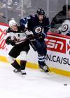 Winnipeg Jets’ Pierre-Luc Dubois (80) and Arizona Coyotes’ Clayton Keller (9) battle for the puck during the first period of NHL action in Winnipeg on Sunday. (Fred Greenslade / The Canadian Press)