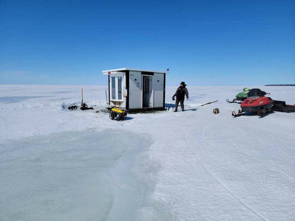 Jordan Manton at Lester Beach, just north of Grand Beach removes his ice-fishing shack. The ordeal started Friday and ended Sunday morning. (Supplied)