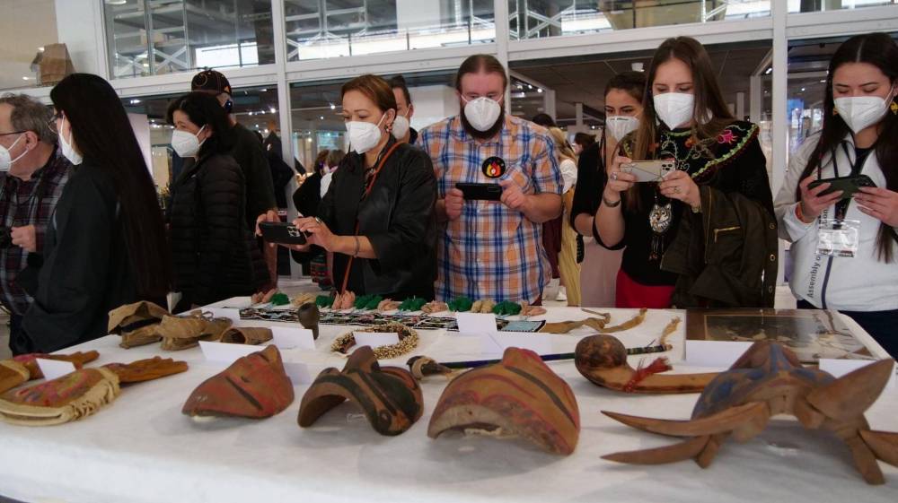 First Nations, Métis and Inuit delegates examine artifacts in the Vatican Museum such as carvings, masks, gloves, pipes, rugs and wampum belts. (Archdiocese of Edmonton)