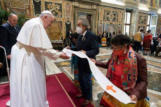 Former national chief of the Assembly of First Nations Phil Fontaine (centre) and residential school survivor Linda Daniels from the Long Plains First Nation (right), presented a leather stole — a liturgical vestment — to Pope Francis at the Vatican in April, 2022. (Vatican Media)