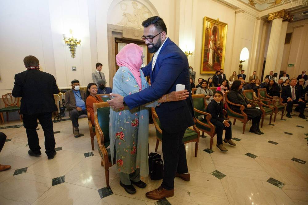 Obby Khan hugs his mother, Rehana Khan, after being sworn in as the province's first Muslim MLA. (Mike Deal / Winnipeg Free Press)