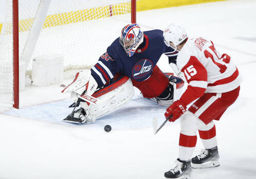 Connor Hellebuyck stops a shot from Detroit Red Wings’ Jakub Vrana during the second period. THE CANADIAN PRESS/John Woods
