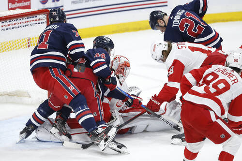 Detroit Red Wings goaltender Thomas Greiss goes down to cover up a shot from Winnipeg Jets’ Josh Morrissey during the first period. THE CANADIAN PRESS/John Woods